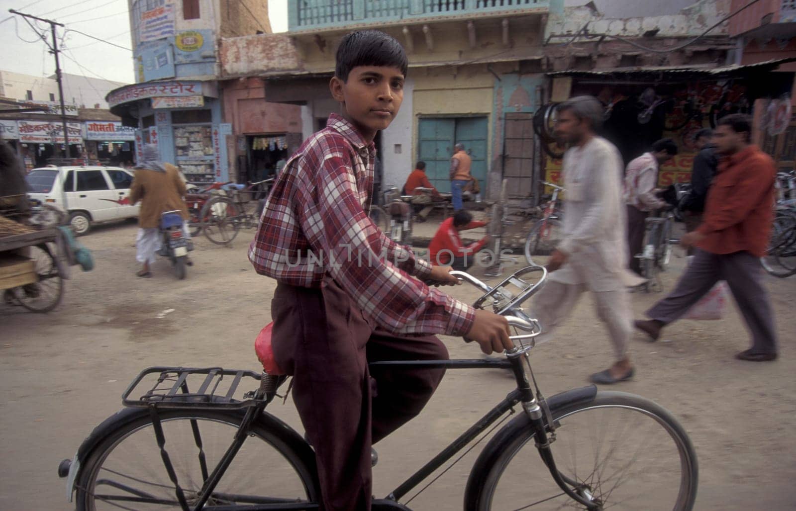 a Bicycle traffic on a road in the City of Jaipur in the Province of Rajasthan in India.  India, Jaipur, January, 1998