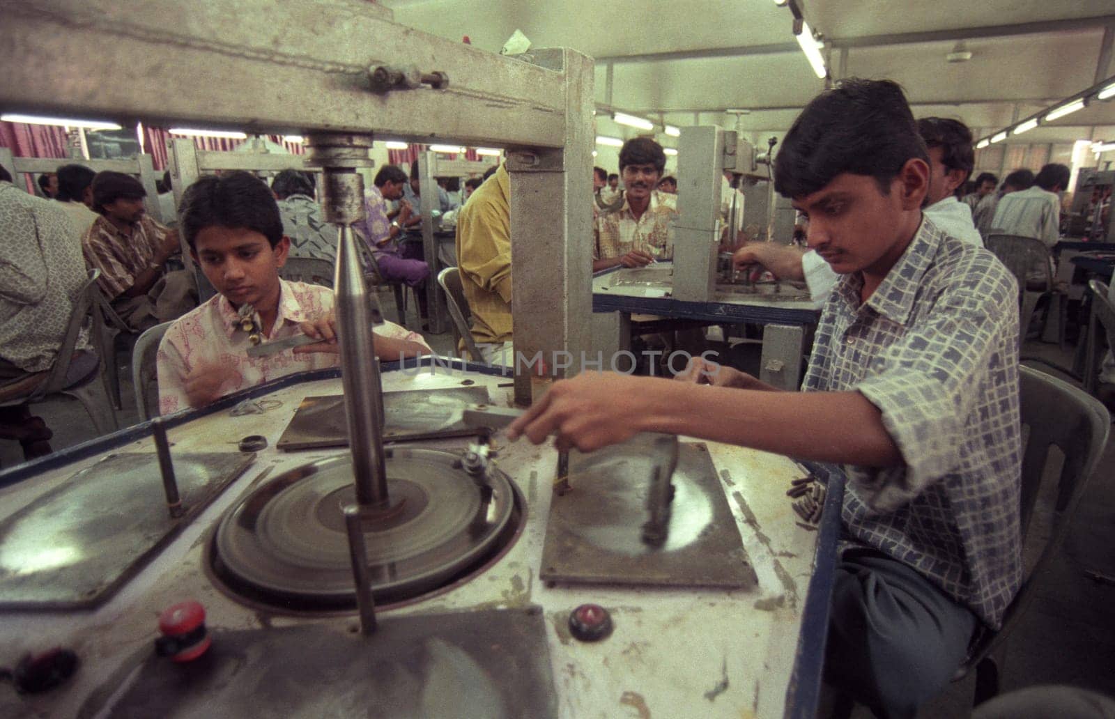 Working People in a Factory of gemstone cutting in the City of Jaipur in the Province of Rajasthan in India.  India, JAIPUR, January, 1998