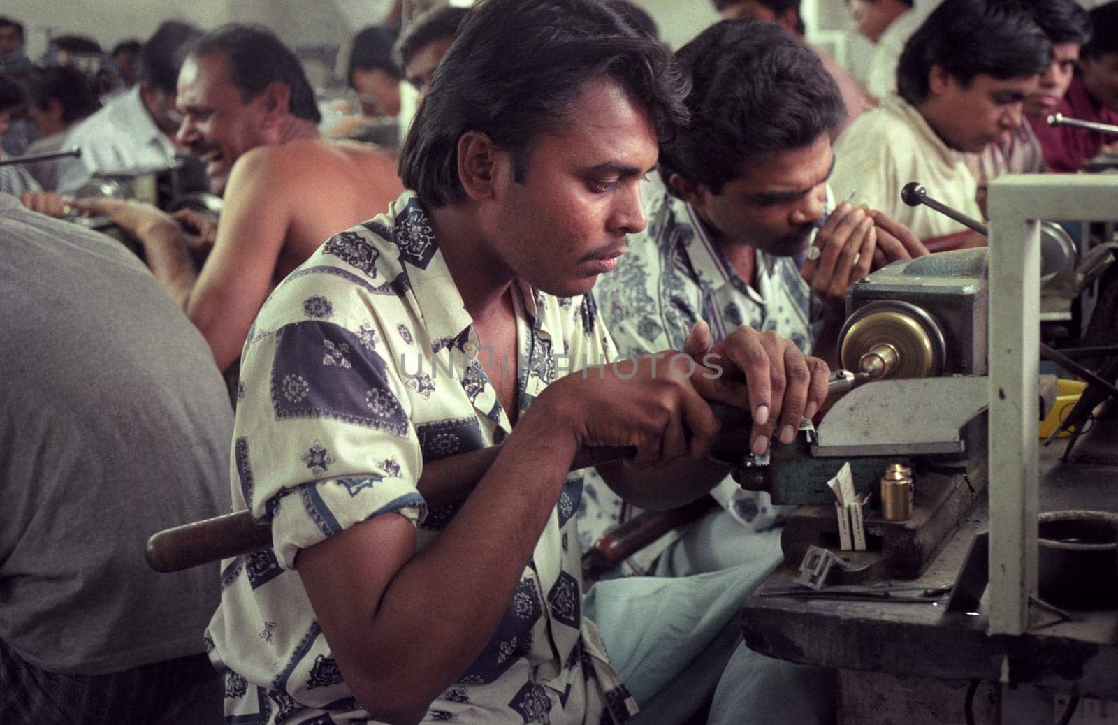 Working People in a Factory of gemstone cutting in the City of Jaipur in the Province of Rajasthan in India.  India, JAIPUR, January, 1998