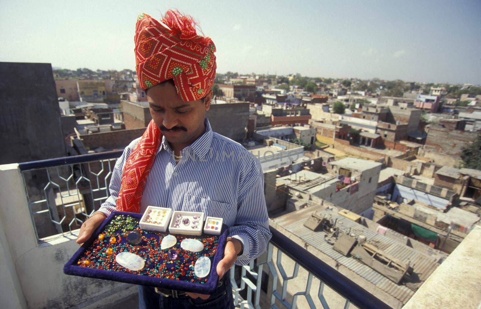 The Boss of a  Gemstone Trading company and Factory of gemstone cutting in the City of Jaipur in the Province of Rajasthan in India.  India, JAIPUR, January, 1998