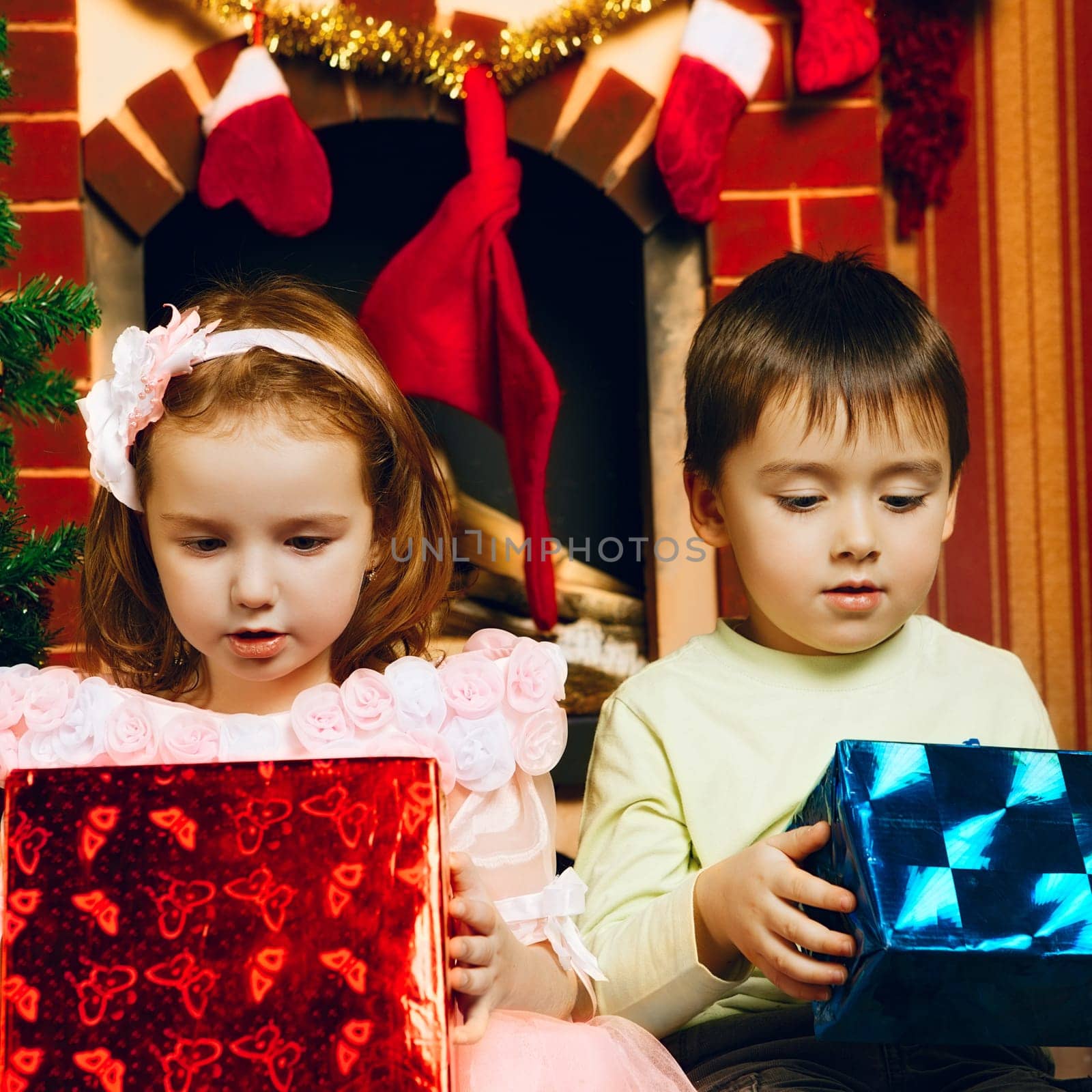 two beautiful child with gift at new year's eve