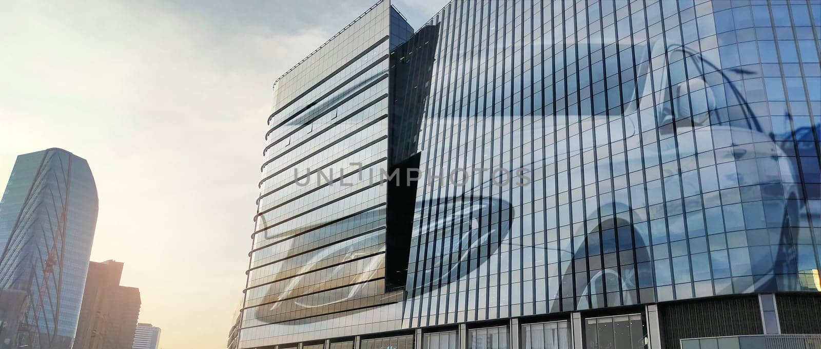 Corporate headquarters building for electric and hydrogen fuel cell car dealership in automotive industry. Modern glass architecture. Sustainable infrastructure. Corporate business environments.