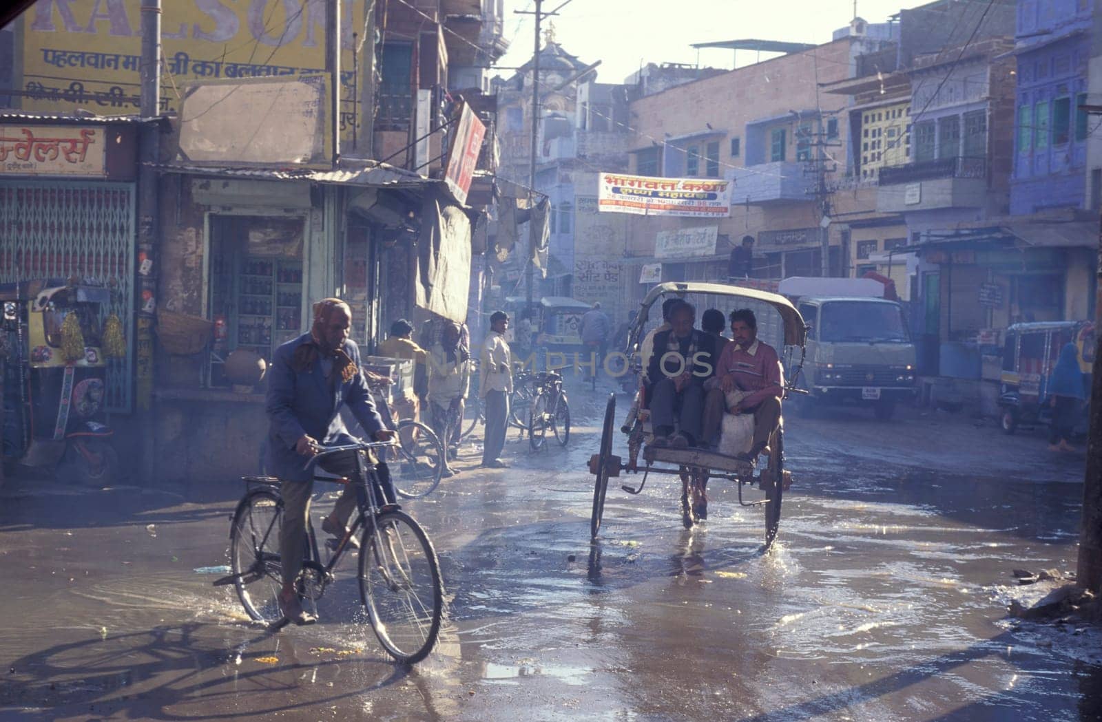 the Traffic with Bicycle and horse cart in the Blue City and Town of Jodhpur in the Province of Rajasthan in India.  India, Jodhpur, January, 1998