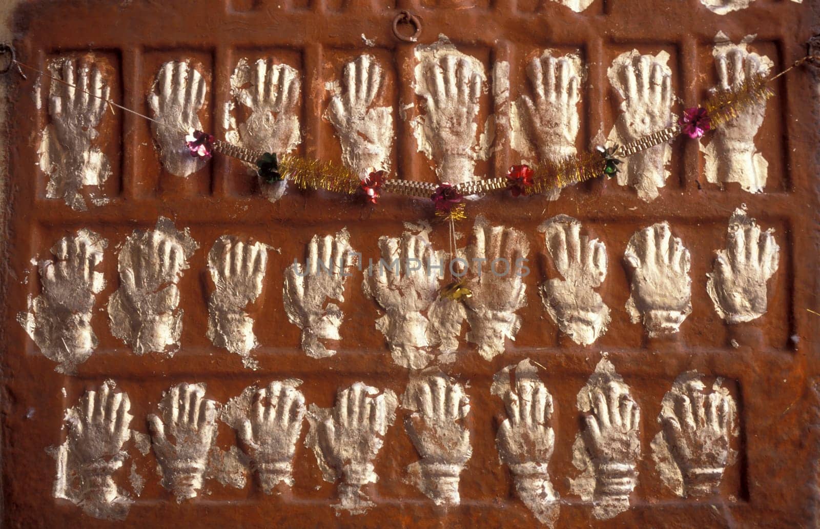 Women Queens Handprints of Sati and grid of Sculpted hands at the Meherangarh in the Town of Jodhpur in the Province of Rajasthan in India.  India, Jodhpur, January, 1998