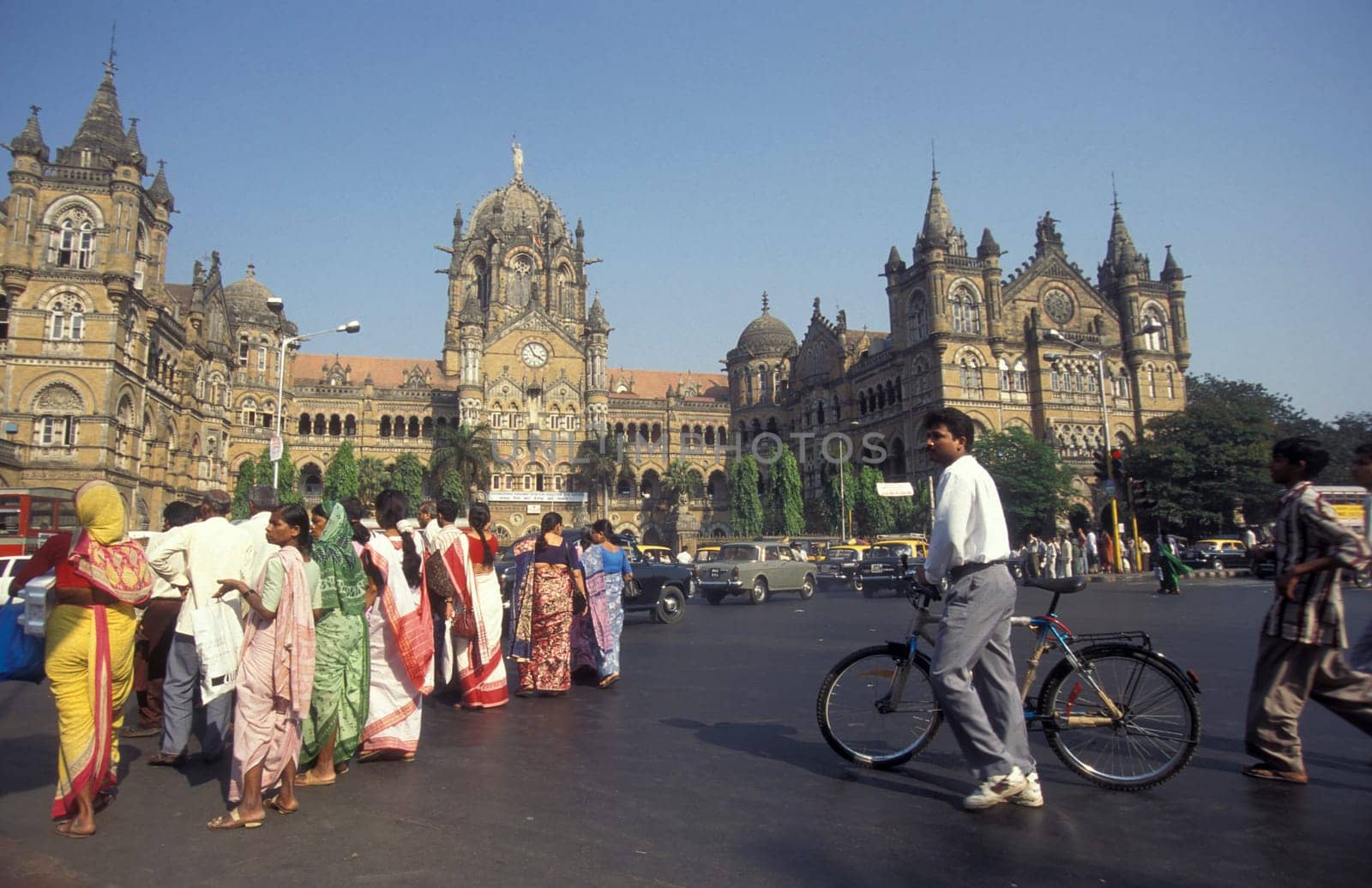 People and Market in front of the architecture of the Mumbai Railway Station or Chhatrapati Shivaji Terminus in the city centre of Mumbai in India.  India, Mumbai, March, 1998