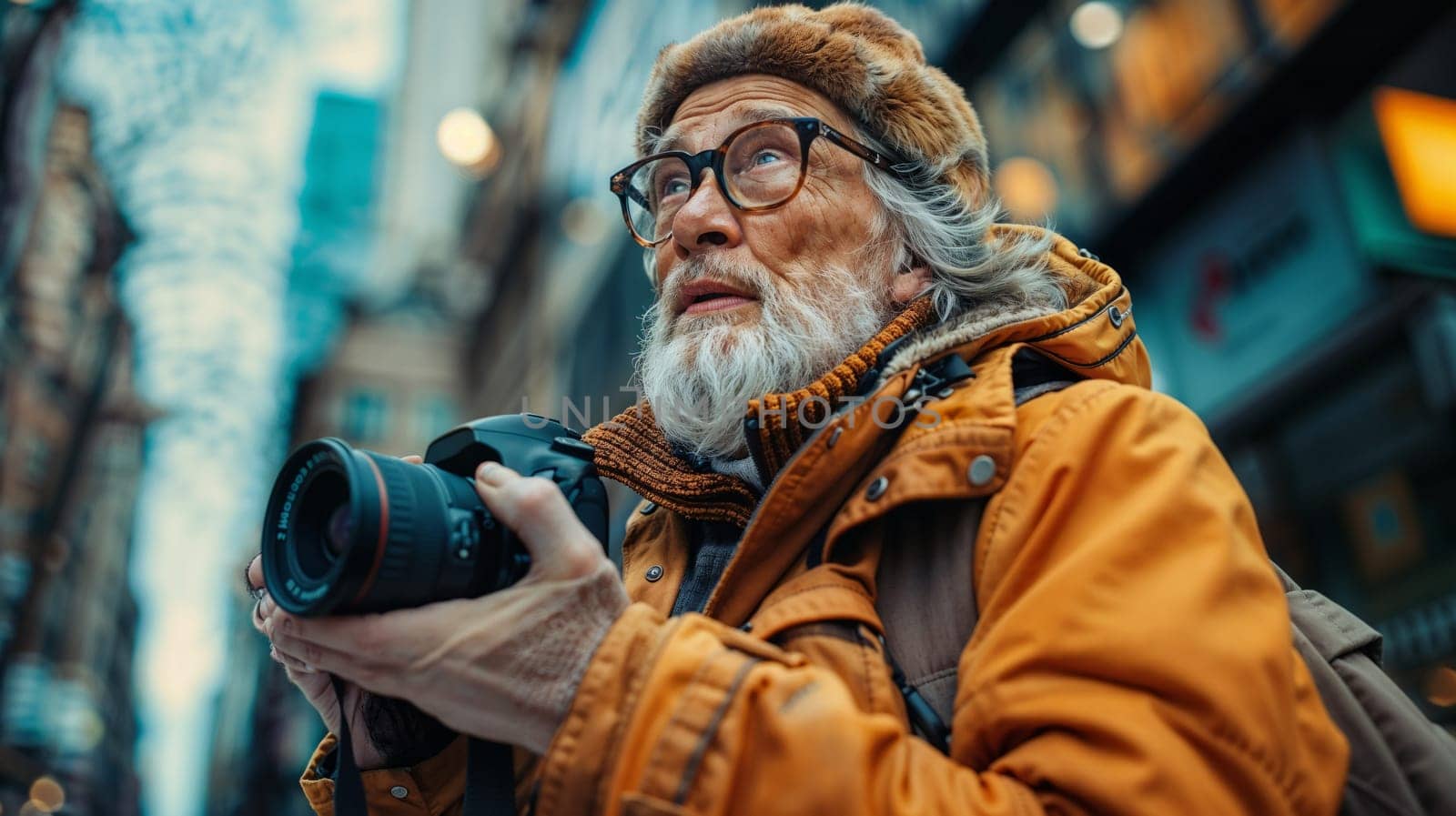 Elderly man in glasses with camera in hands