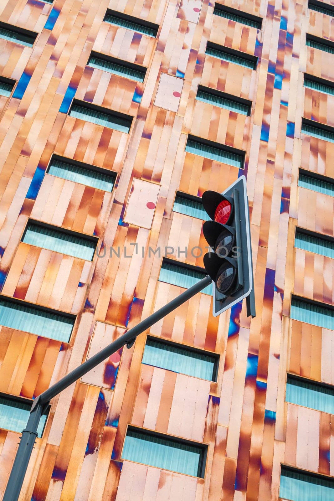 Lille, France - August 16 2022: Facade of the Crowne Plaza Hotel Lille-Euralille and red traffic light in Lille, France