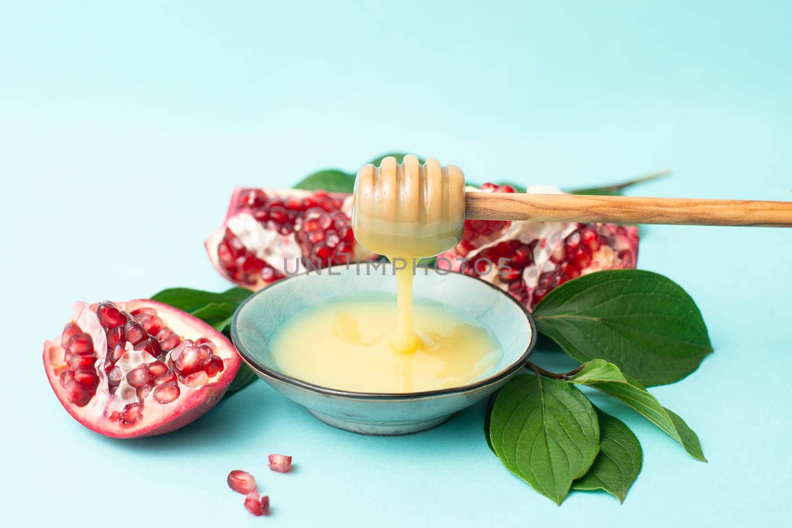 Rosh hashanah, jewish new year holiday, background with pomegranate and honey, traditional food for celebration