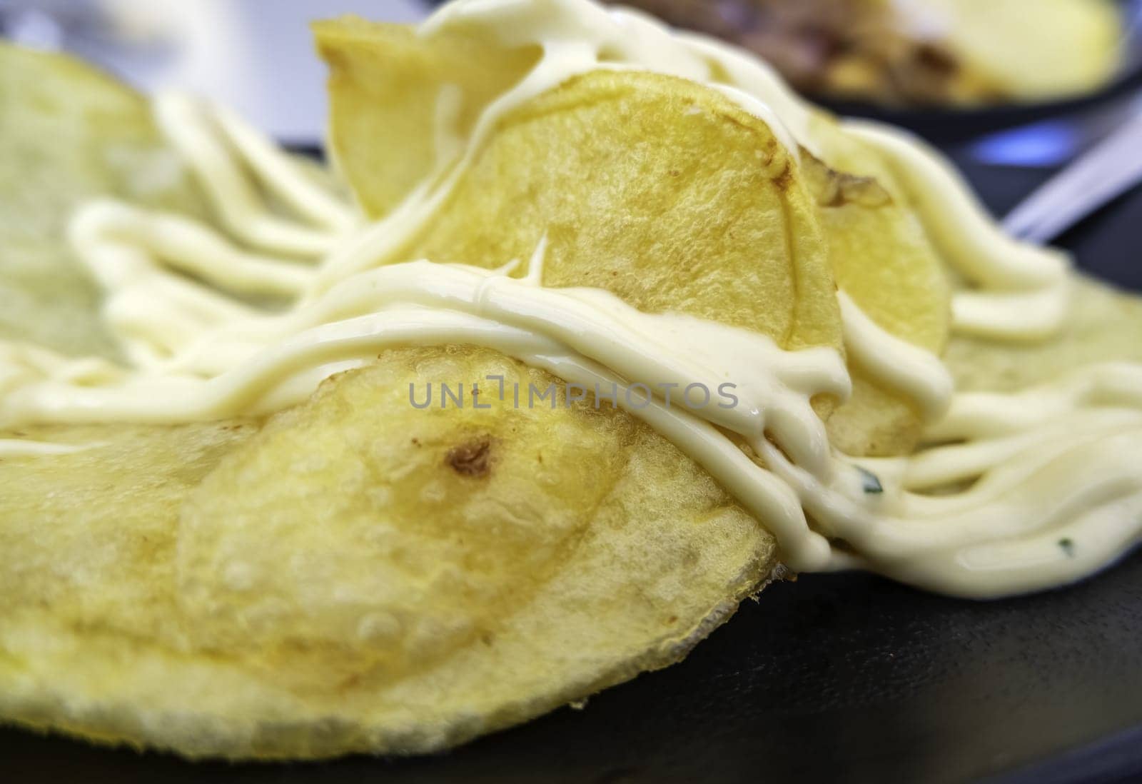 Detail of cold potatoes with sauce, lunch and fun