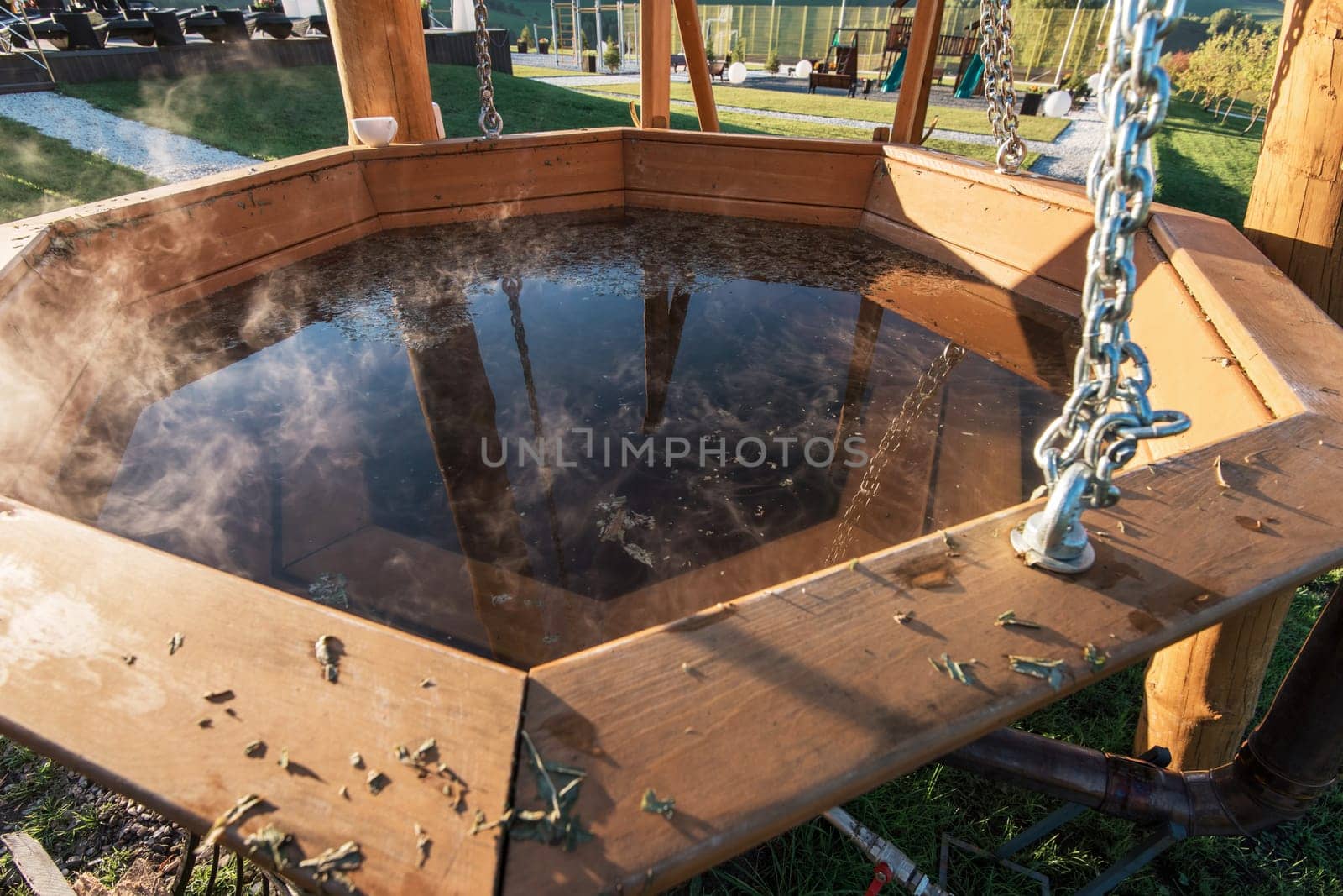 Big vat with hot water and herbs for bathing, spa and relax. Outdoor in Altai mountains, Siberia, Russia