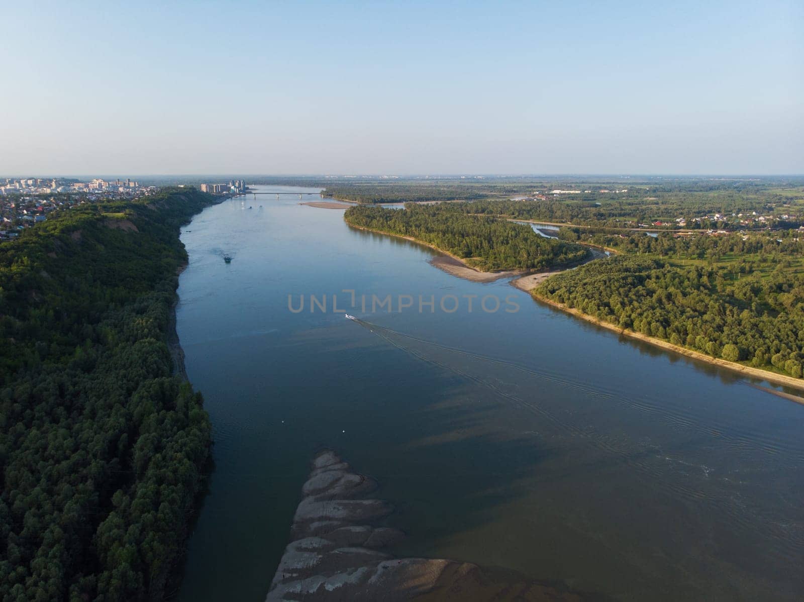 Aerial view of big siberian Ob river and ship, summer day, drone shot