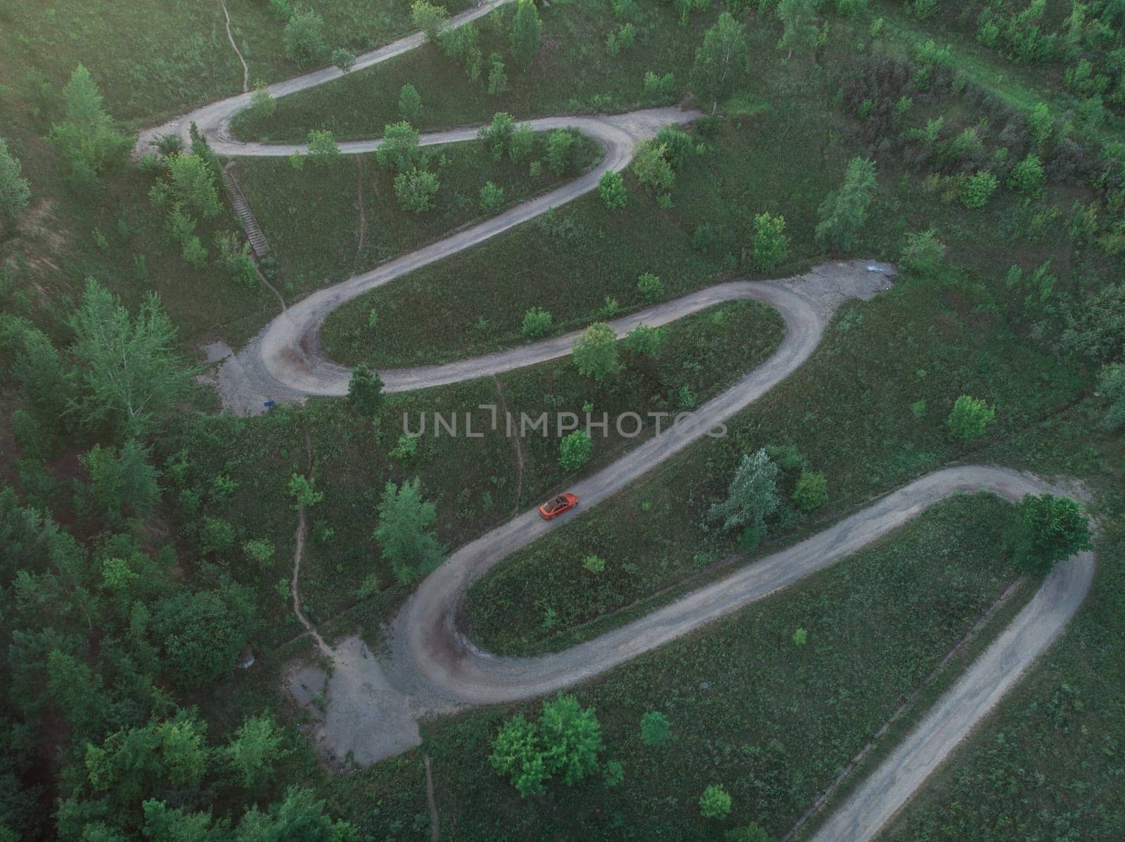 Aerial top vew of winding road in the city, drone shot