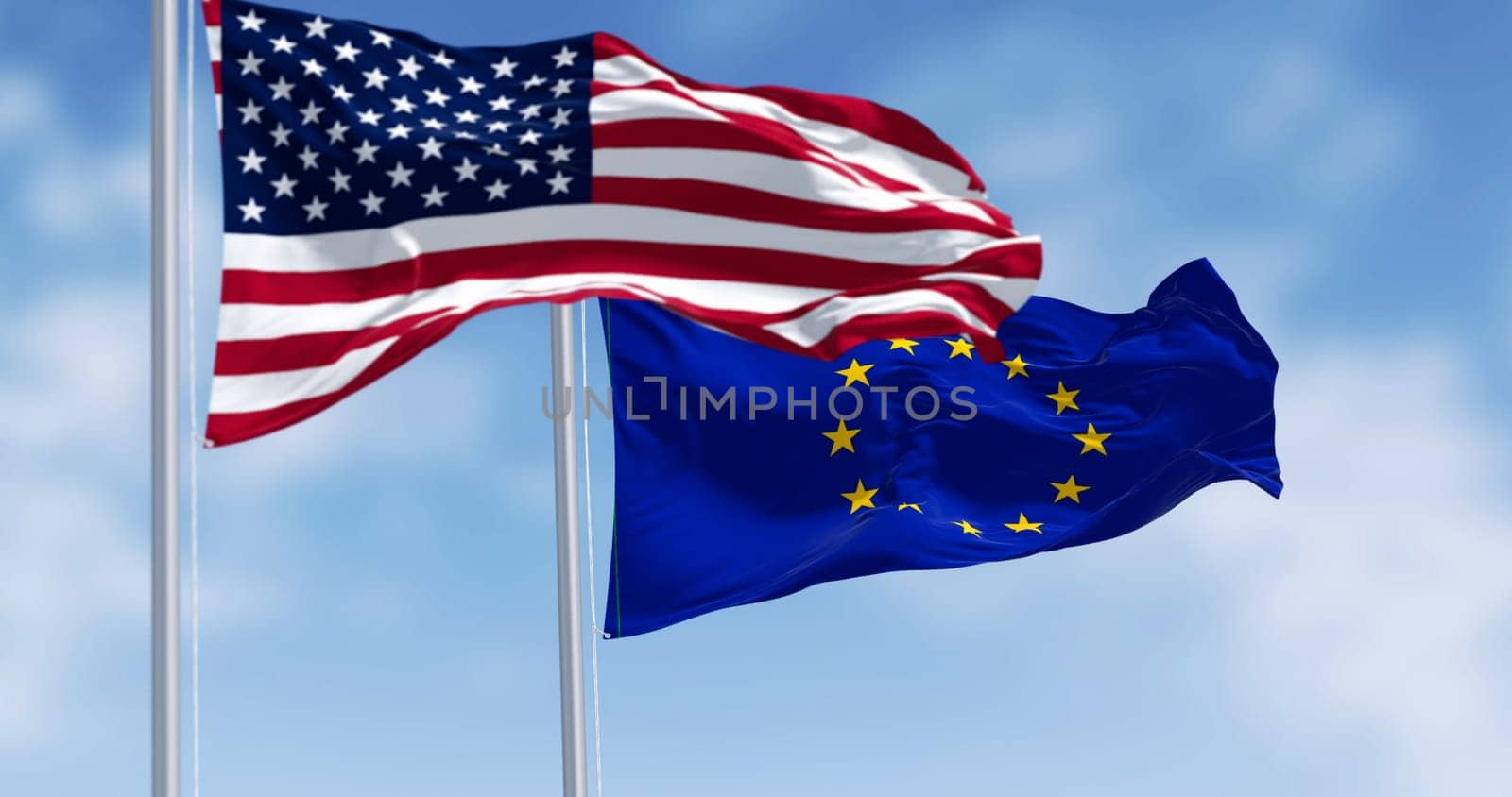 The flags of the United States of America and the European Union waving in the wind on a clear day. 3D illustration render. Rippled fabric. Selective focus. International politics, alliance