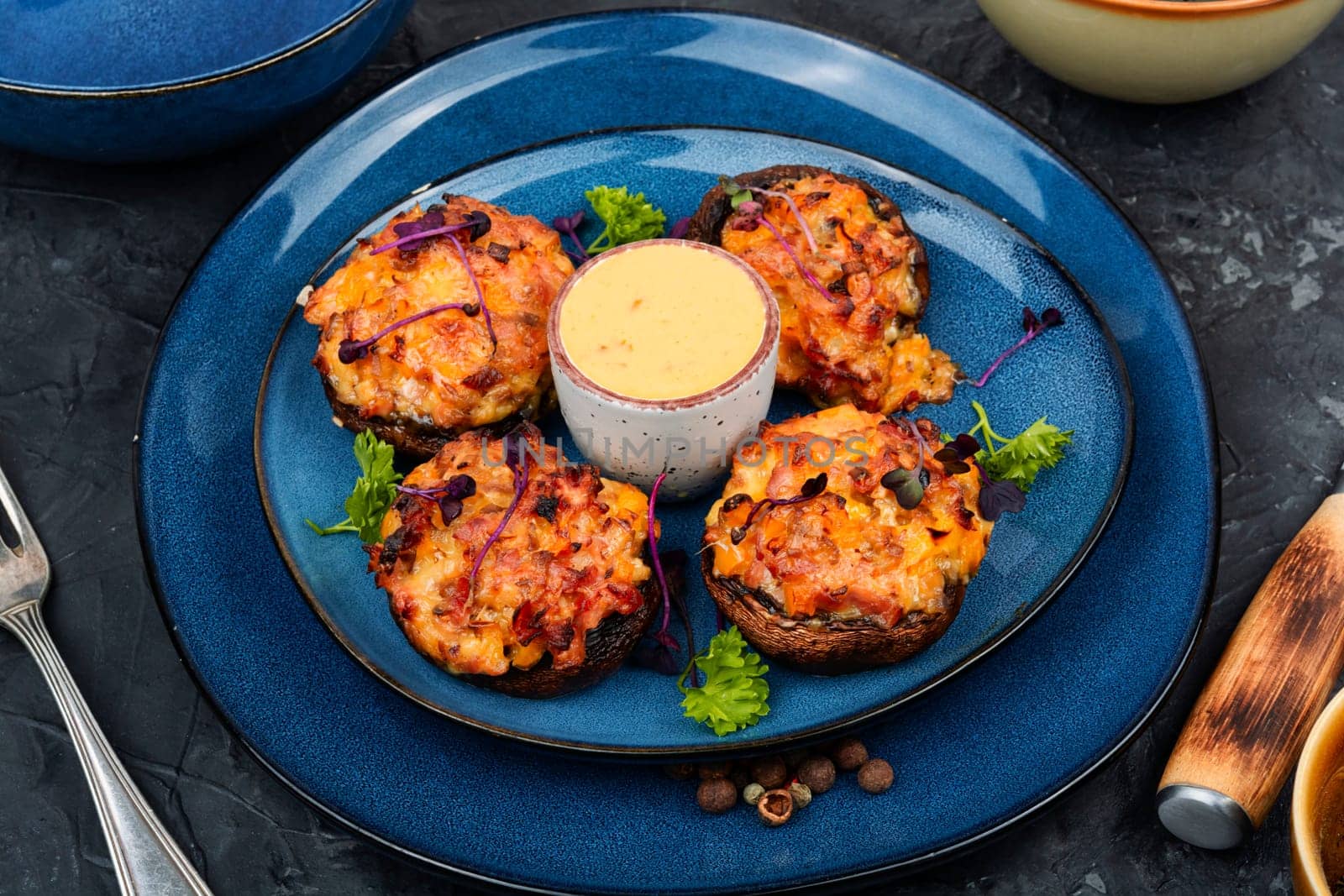Delicious stuffed mushrooms, champignon mushroom caps stuffed with vegetables. Top view.