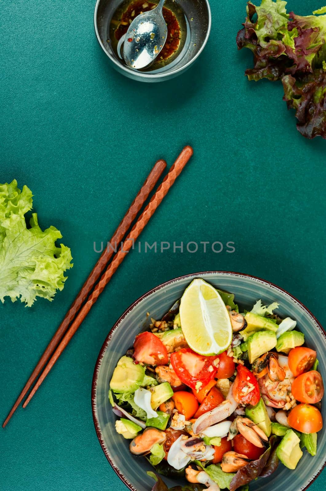 Salad with calamari, shrimp, clams and fresh vegetables. Copy space.