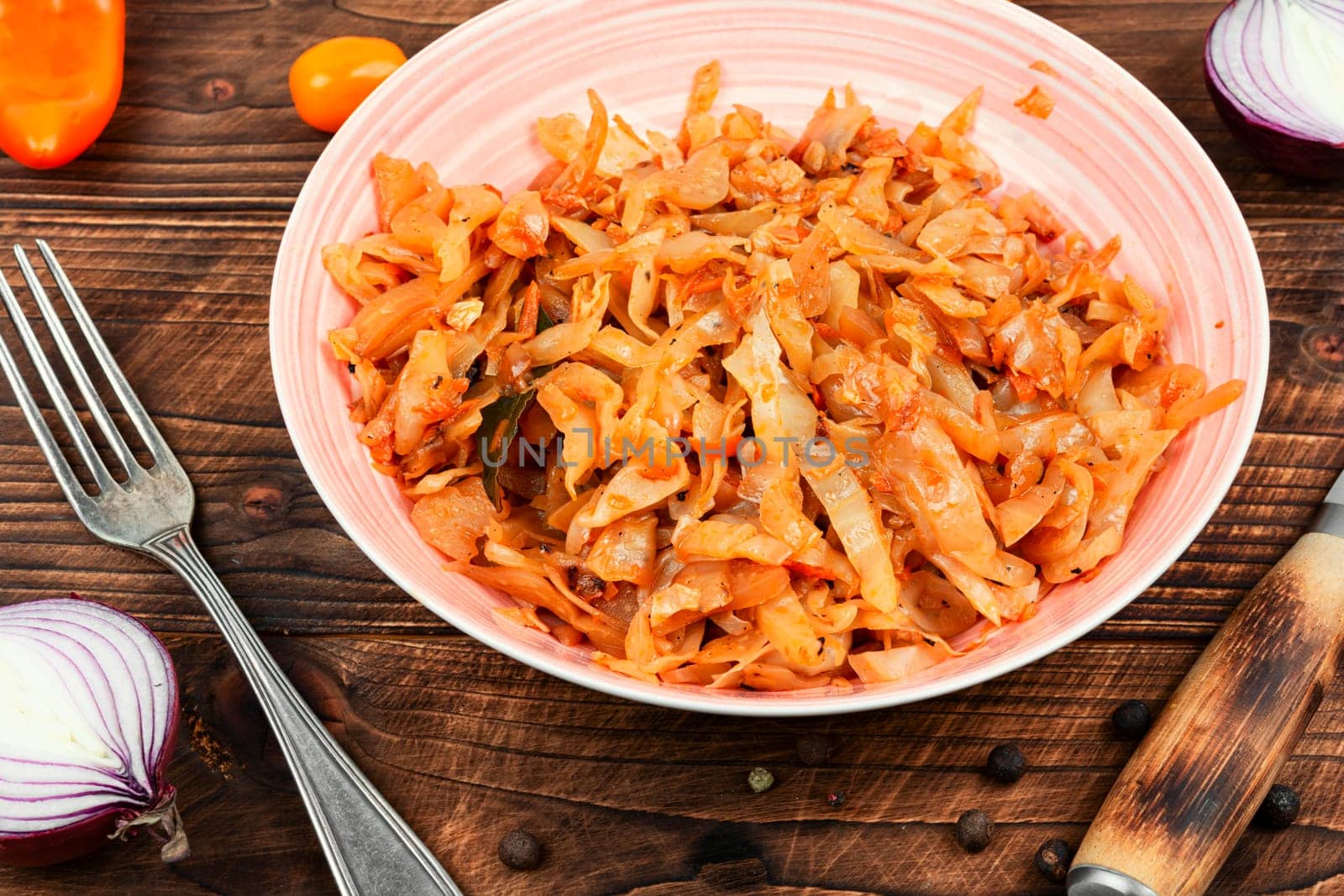 Appetizing stewed cabbage on a plate. German cuisine. Rustic style.