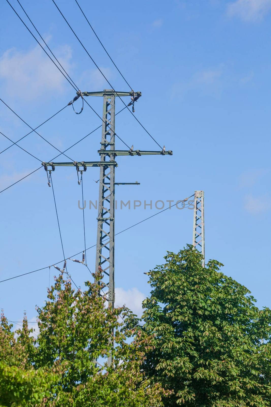 Power line, power poles, railroad system, blue sky, Germany