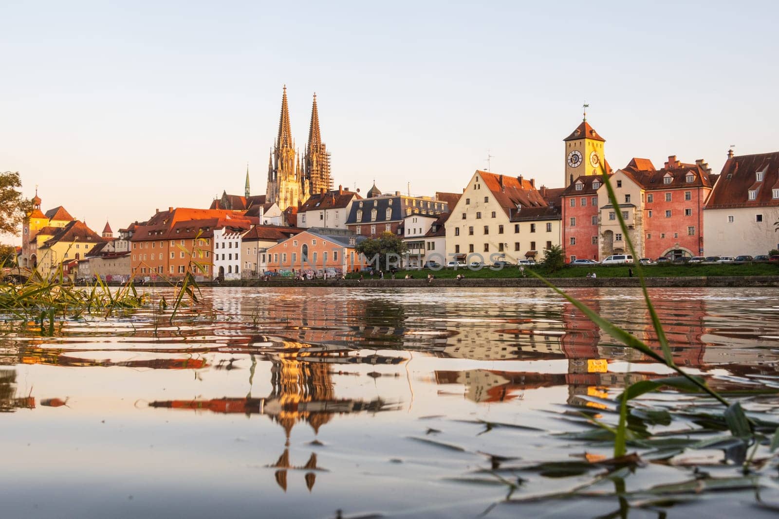 Regensburg in Germany, view to the old town with relection in the Danube river in the foreground