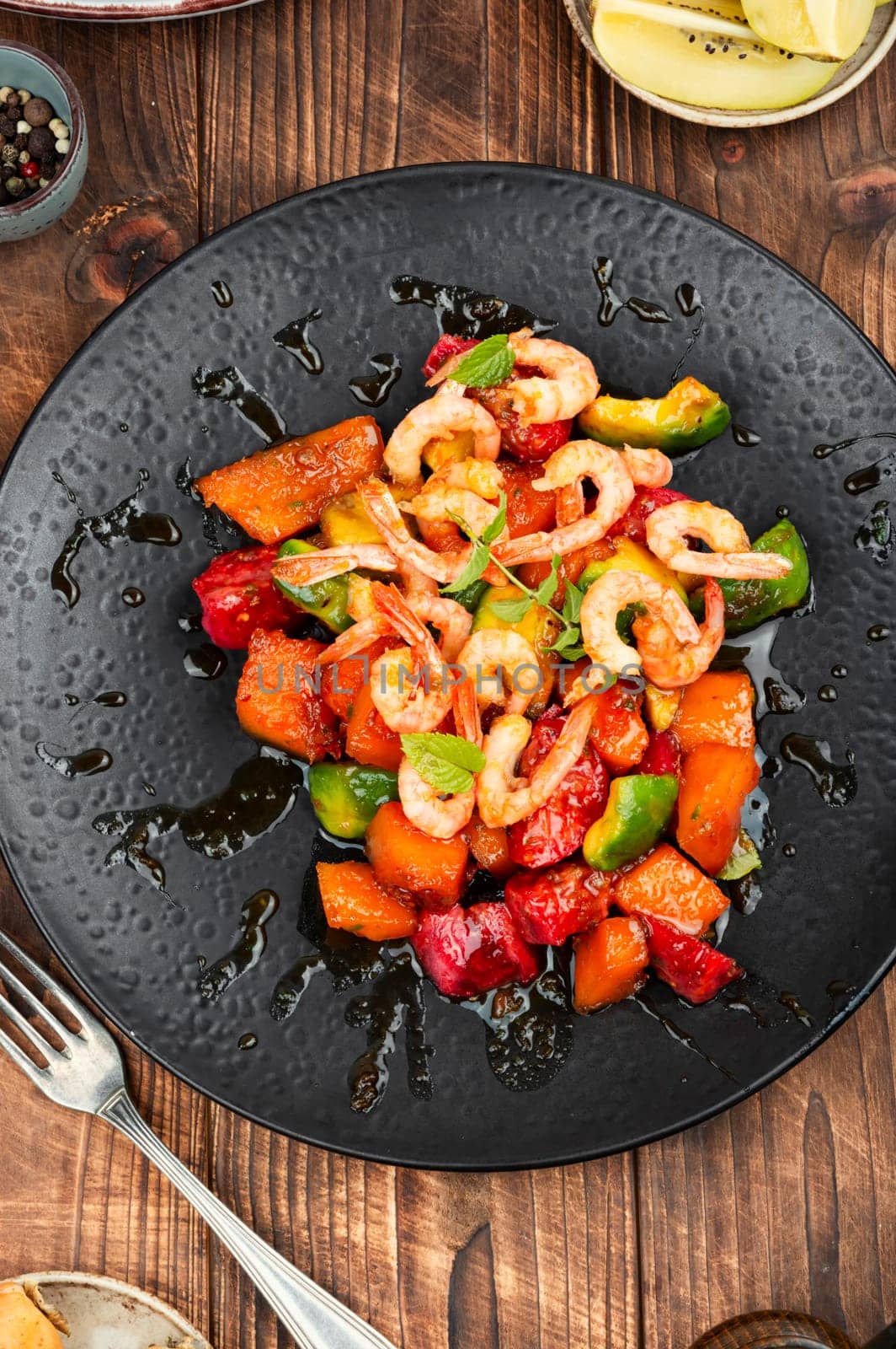 Fried crispy shrimp with fruit sauce. Salad with shrimps, prawns and caramel sauce.