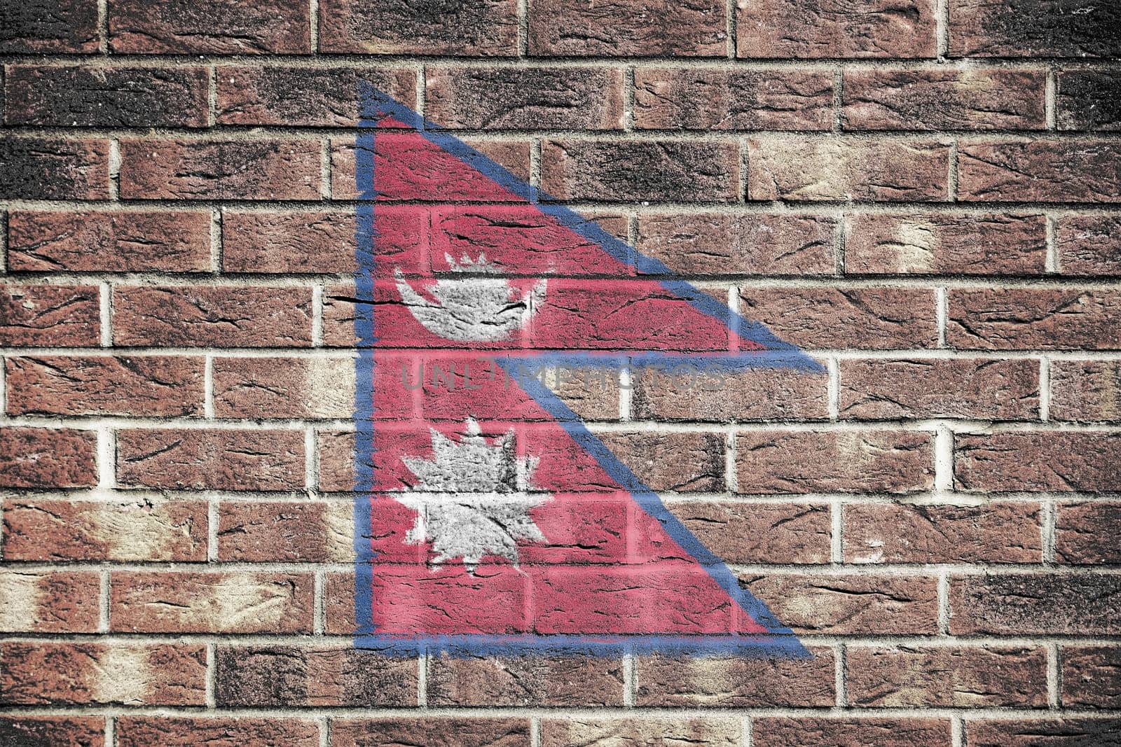 A Nepal flag on old brick wall background