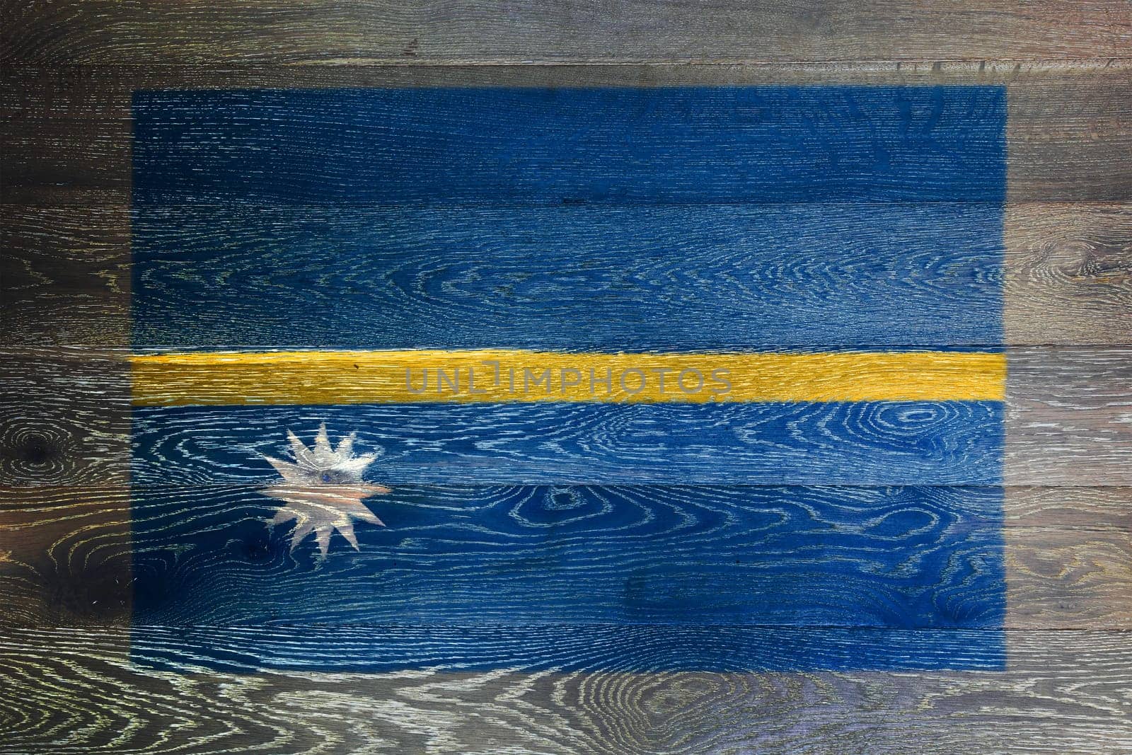 A Nauru flag on rustic old wood surface background blue yellow stripe white star