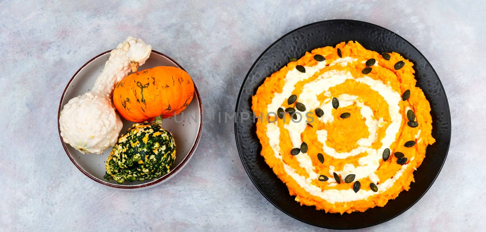 A colorful pumpkin risotto with pumpkin puree and parmesan cheese.