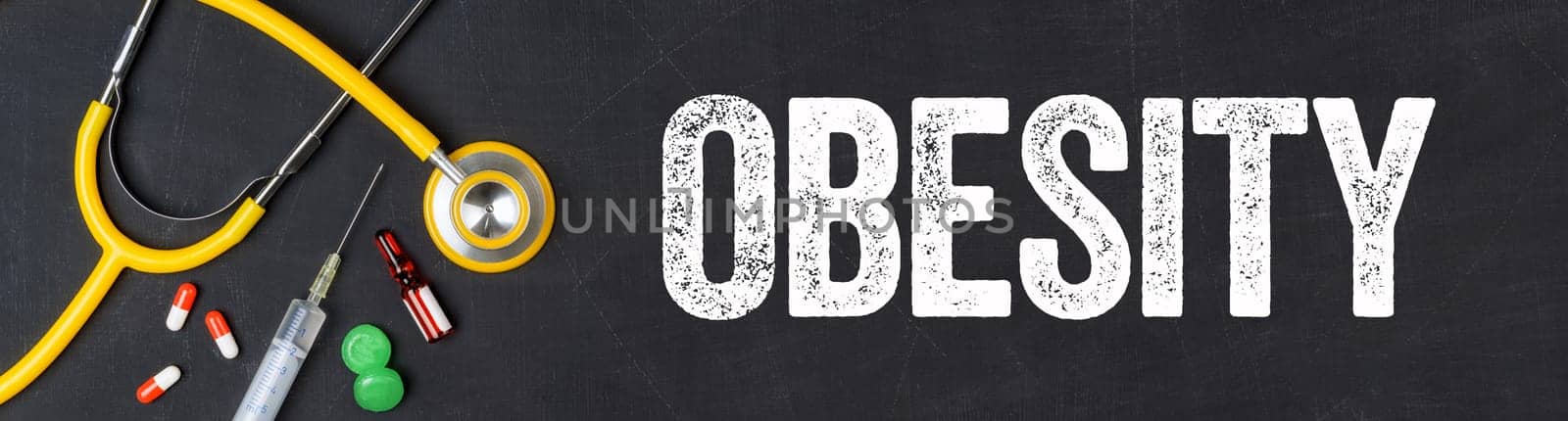 Stethoscope and pharmaceuticals on a blackboard - Obesity