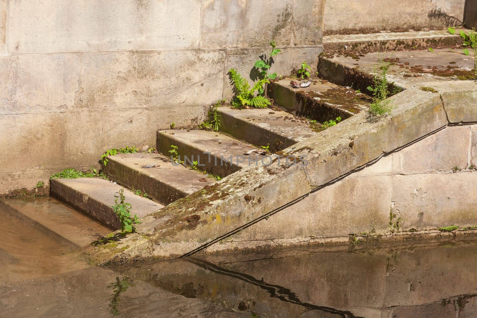 Old brown steps by a body of water, Germany