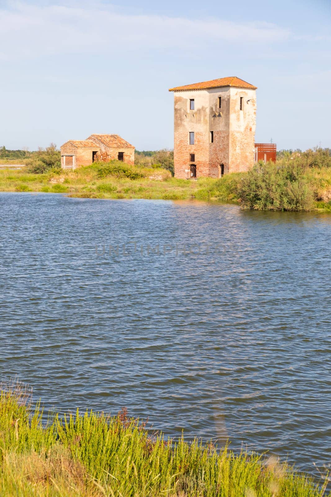 Italy, Comacchio lagoon with blue sky. Panorama with country and canals.