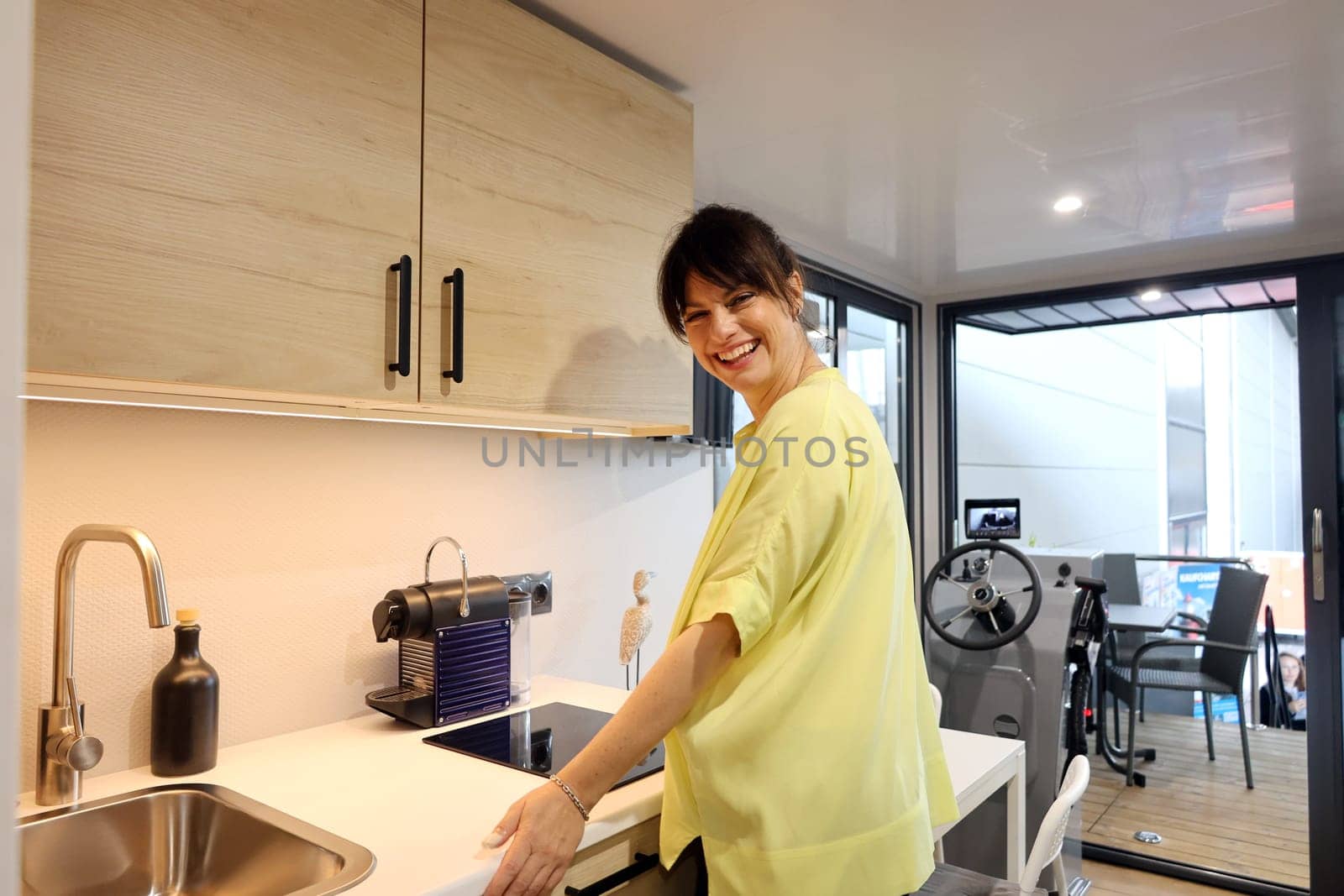 Nothing is missing in the small kitchen: Model Cora is visibly having fun at the trade fair novelty,the brand new houseboat   The Interboot 2024 Friedrichshafen trade fair will open its doors on 25.09.2024