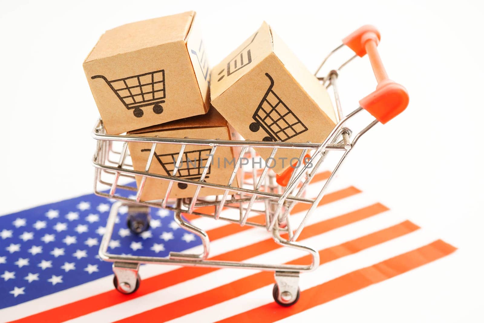 Online shopping, Shopping cart box on US America flag, import export, finance commerce.