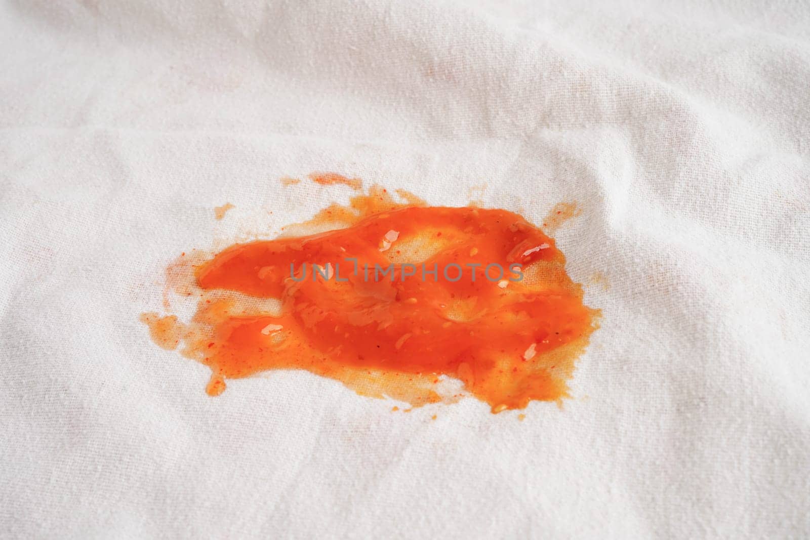 Dirty spicy sauce stain on cloth to wash with washing powder, cleaning housework.