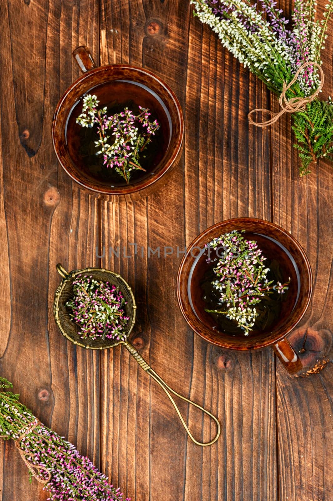 Herbal tea with fresh heather, homeopathy. Heather blossom tea on wooden table.