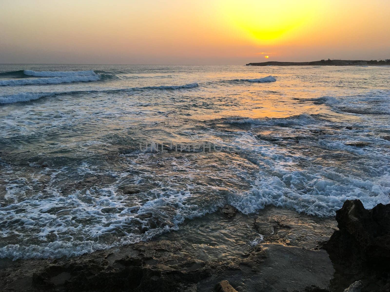 Sunset in Cyprus. View of coast at sunset. Promenade of the Mediterranean sea. Evening landscape of Cyprus