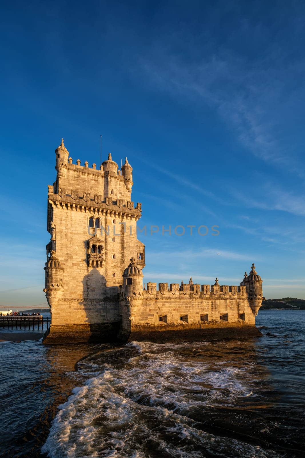 Belem Tower or Tower of St Vincent - famous tourist landmark of Lisboa and tourism attraction - on the bank of the Tagus River Tejo on sunset. Lisbon, Portugal