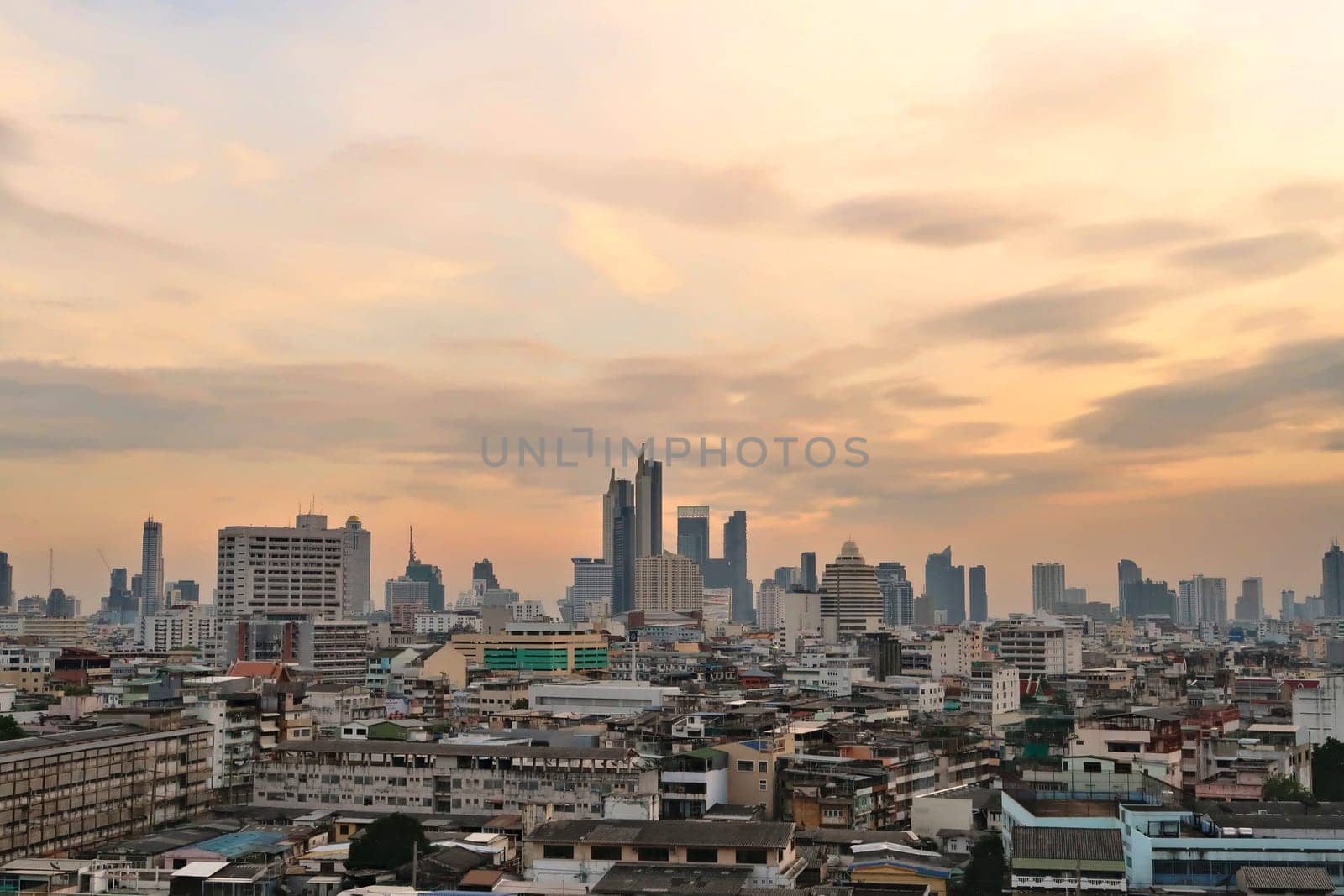 View onto the skyline of Bangkok before sunset, skyscrapers under a cloudy sky, Thailand 2023