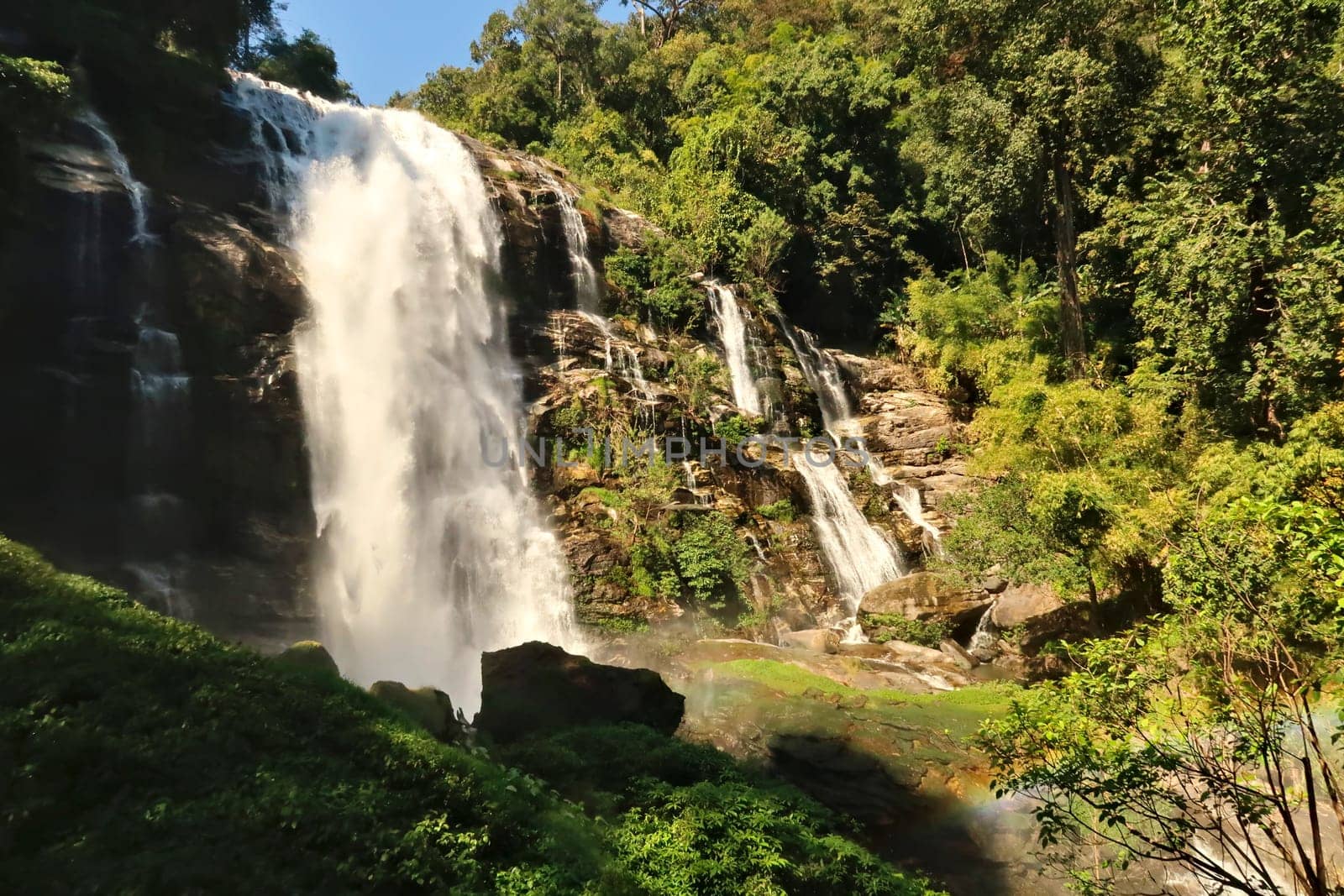 View onto the Wachirathan Waterfall, Wachirathan Falls with a small rainbow in the foreground, Mae Hong Son Loop, Doi Inthanon National Park, Thailand 2023