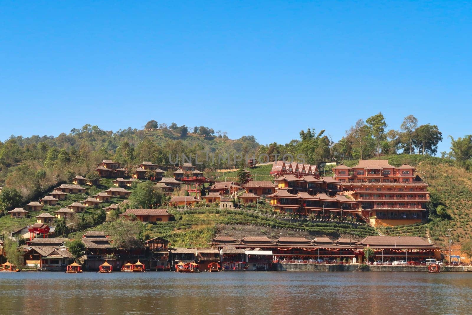 Picturesque view from the lake onto the Ban Rak Thai, Mae Aw Village, a chinese village in northern Thailand, close to the border to Myanmar, Mae Hong Son Loop, Thailand 2023