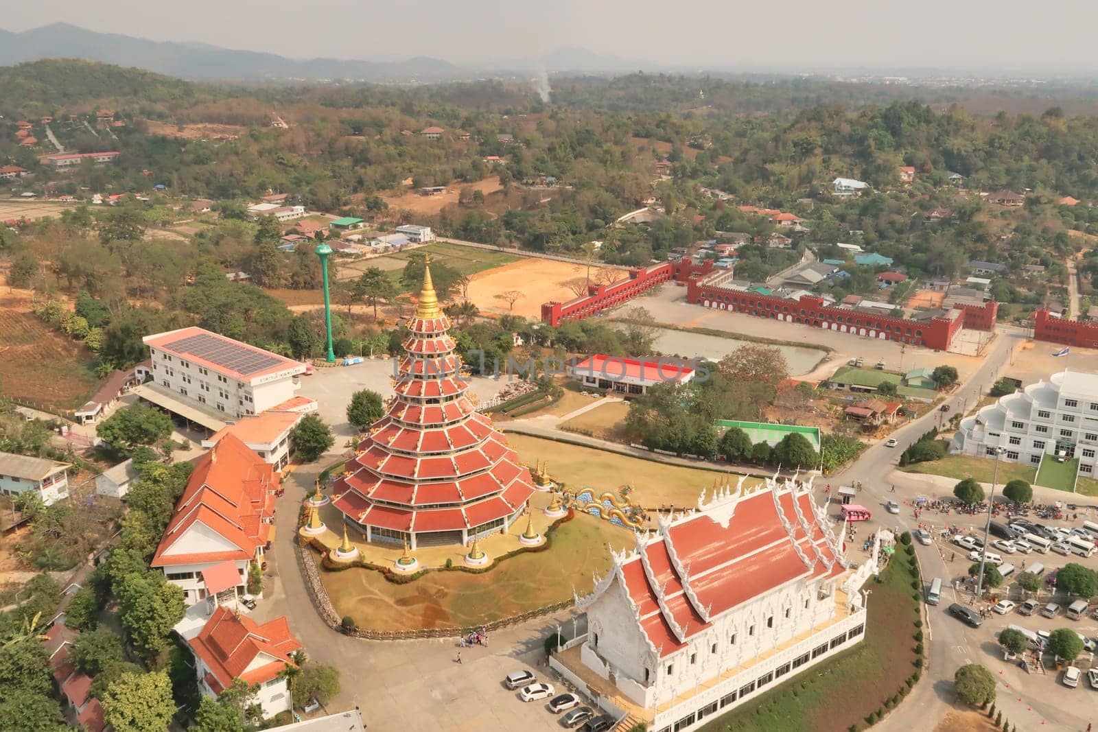 View from the highest, top floor inside the head of the Guan Yin Statue onto the Phop Chok Dhamma Chedi, the Wat Huay Pla Kang Temple and the surrounding landscape Chiang Rai, Thailand 2023