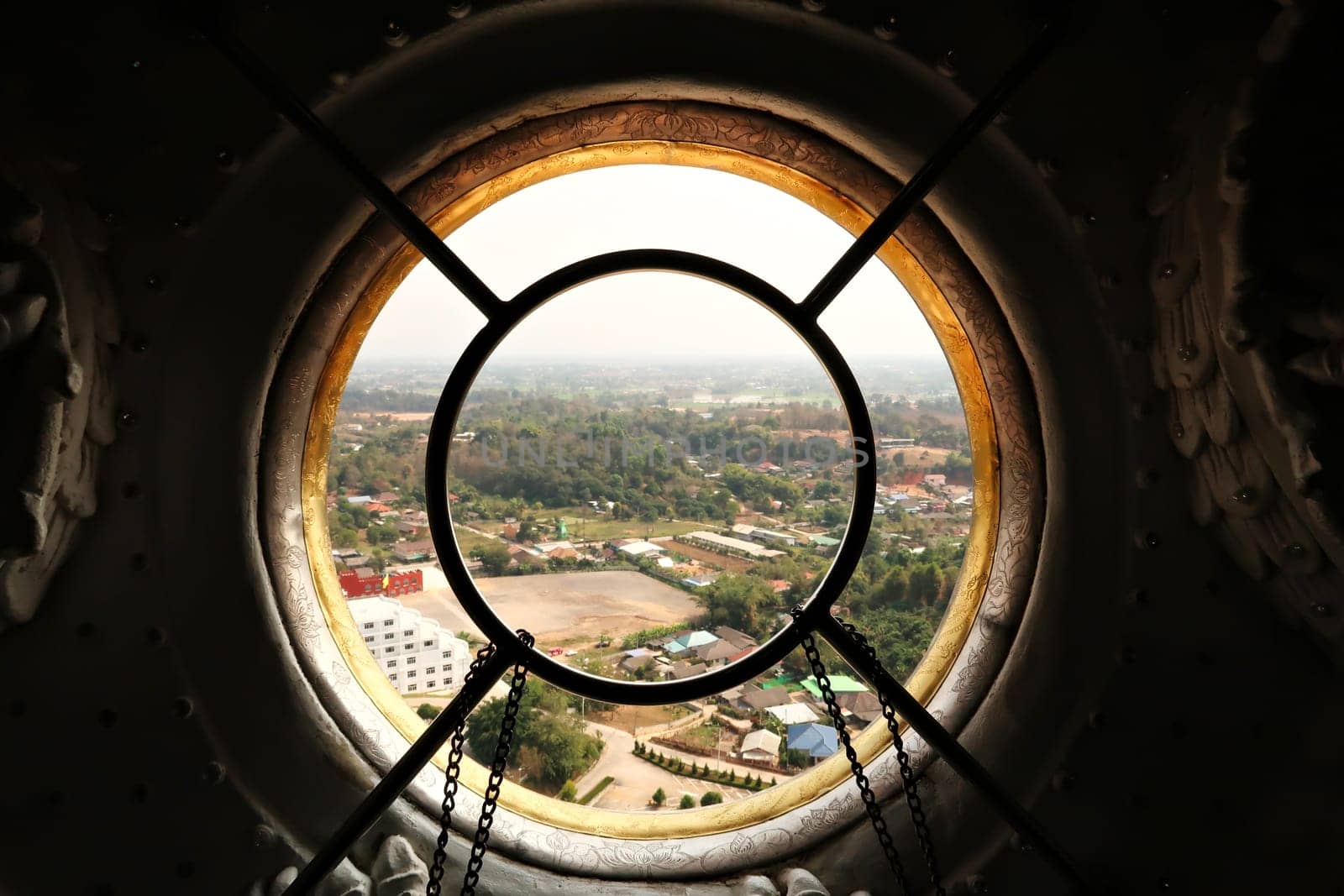 View through a window from the highest floor, top floor inside the head of the Guan Yin Statue onto the surrounding landscape, Wat Huay Pla Kang Temple Complex, Chiang Rai, Thailand 2023