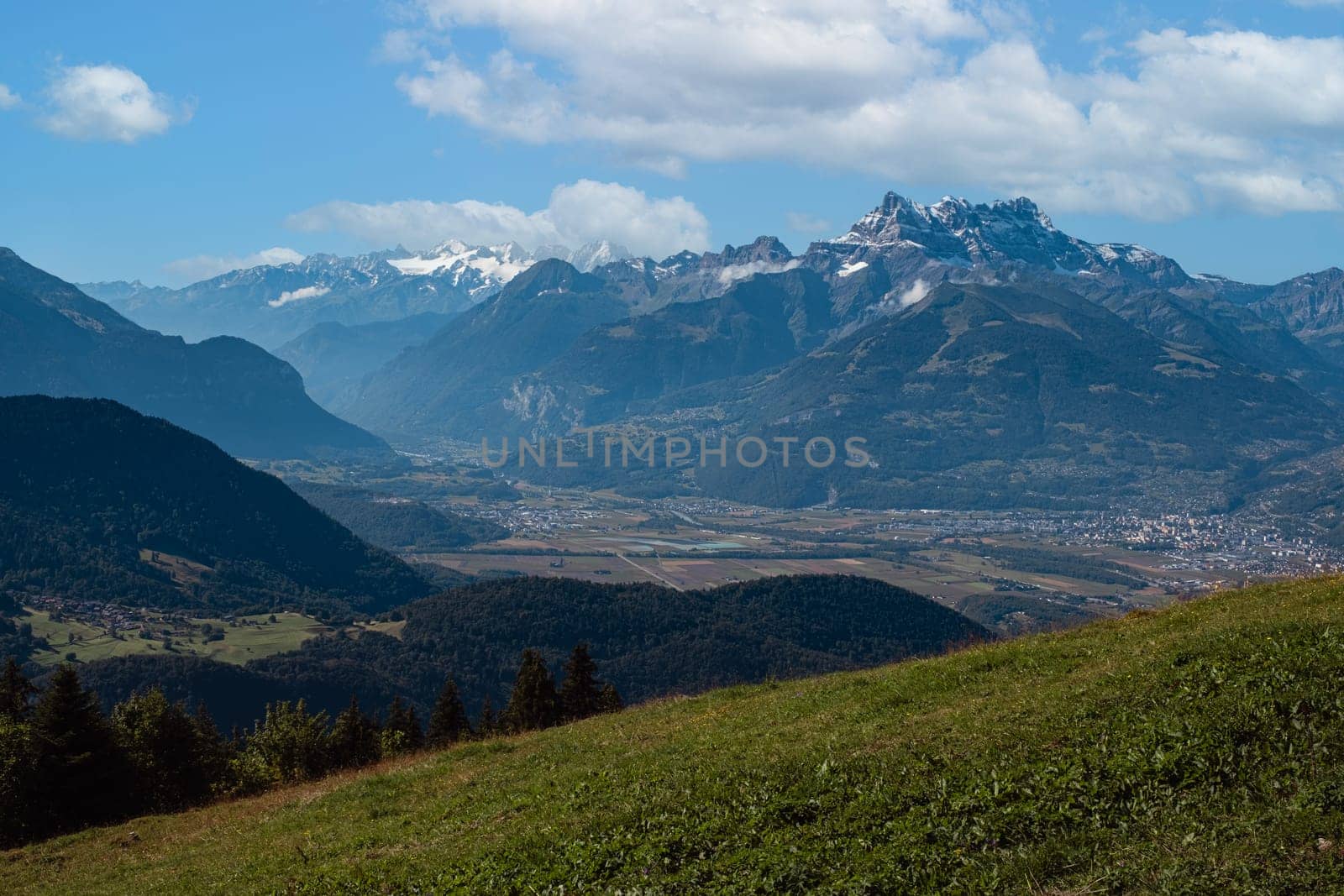 Rhone valley panorama and Dents du Midi on a cloudy day in summer seen from Leysin , Vaud, Switzerland