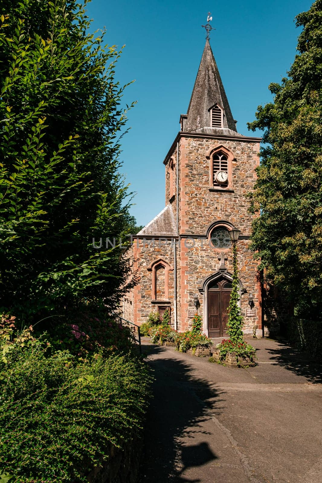 Saint-André church near the Coo Waterfalls on a summer day. Stavelot, Province Liege, Wallonia, Belgium