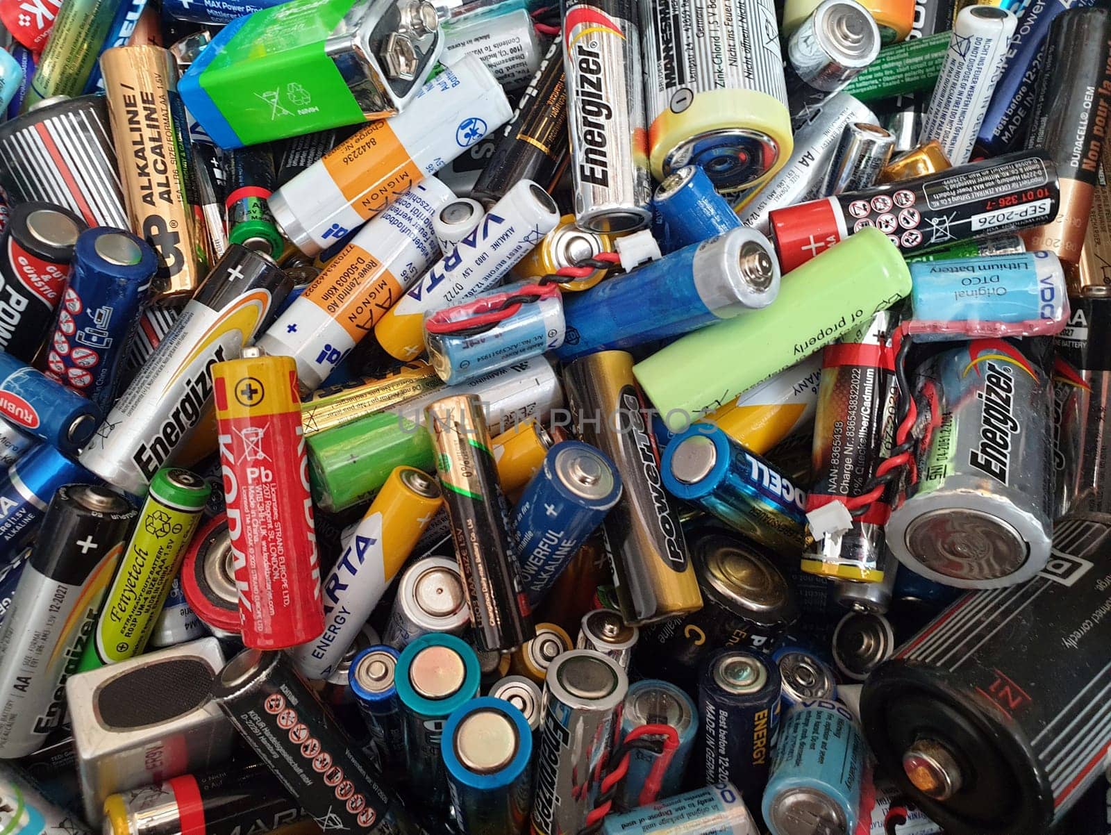 Lots of different types of batteries in varying colors - AAA, AA, C, D Nine-volt and others