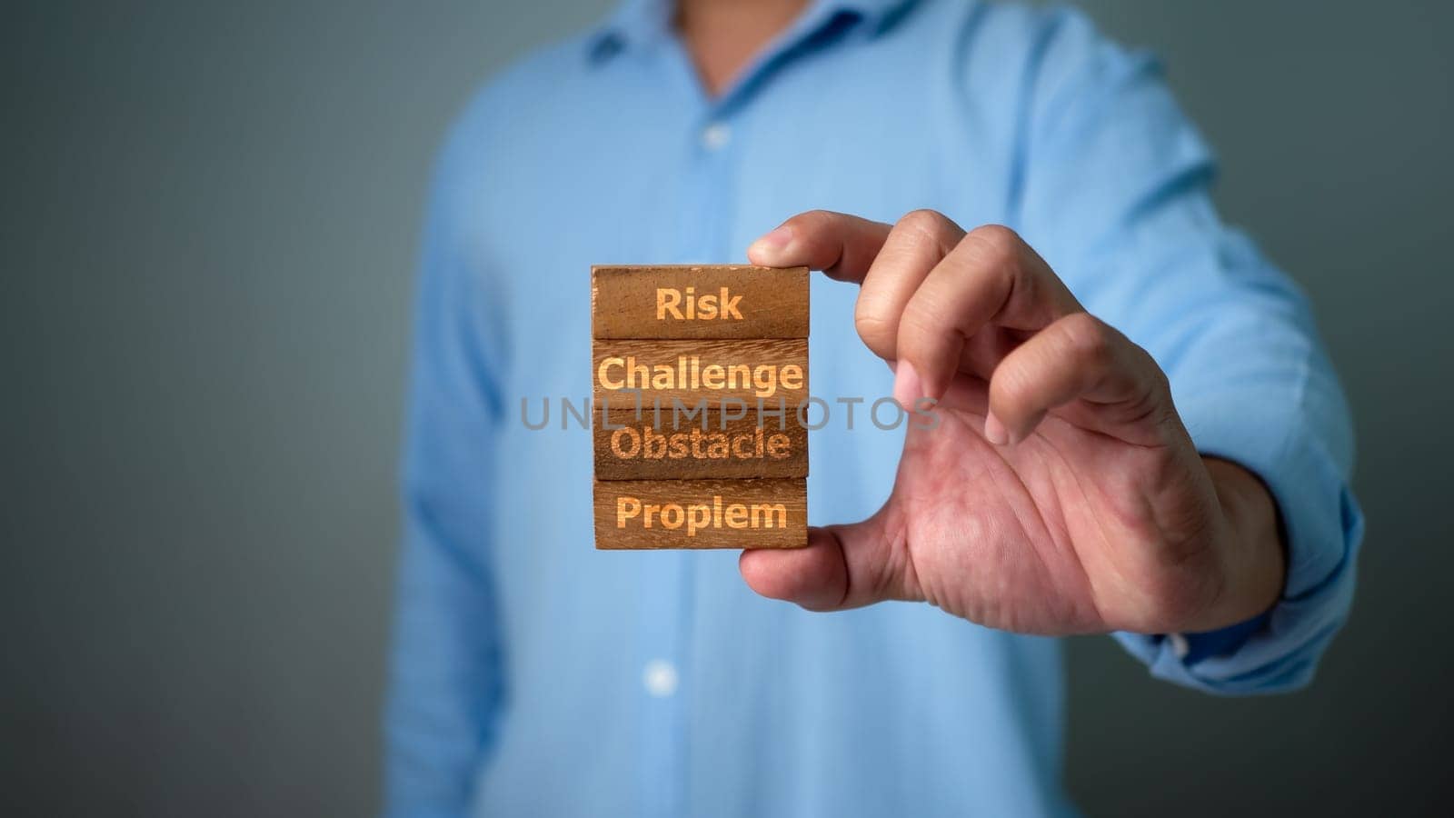 Human hand holding wood blocks in risk management concept, Challenge, Obstacle, Financial risk management concept ,Business Investment Feasibility Assessment, Business risk analysis.
