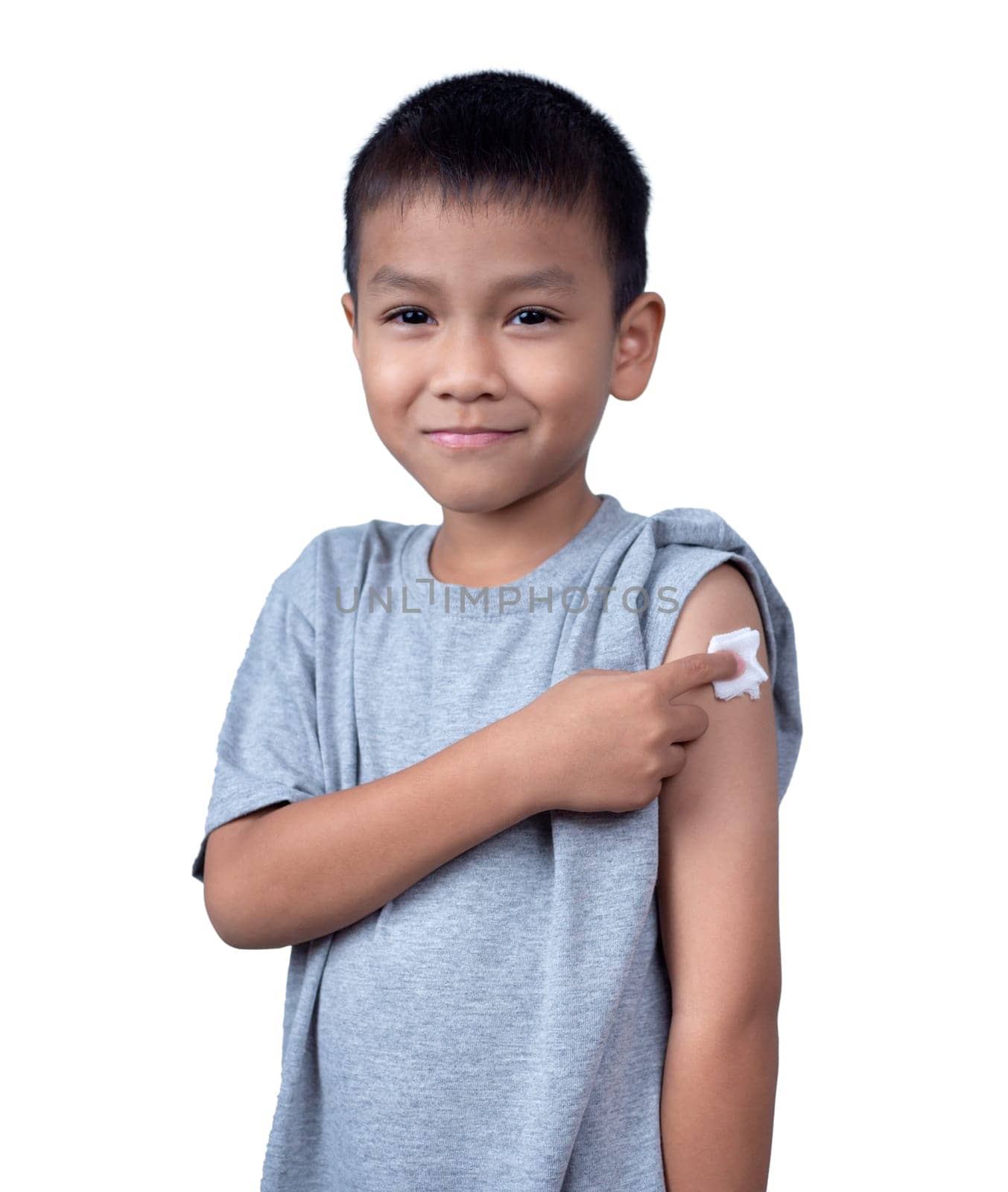 Little asian child boy wearing short-sleeve shirt with bandage plaster on her arm after vaccination for boost immunity. Injection covid vaccine, Tetanus vaccine, Flu vaccine, healthcare for children.
