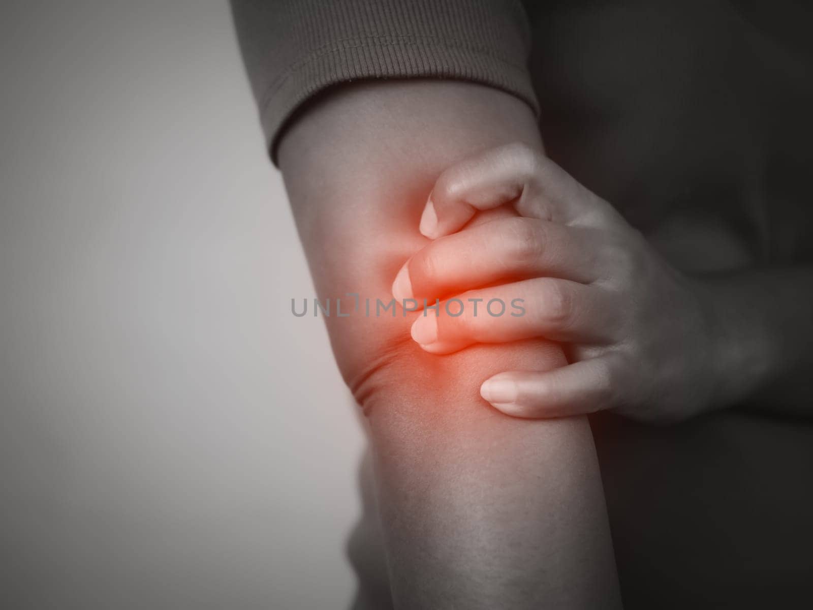 Woman with acute pain elbow on gray background, Woman having elbow ache due to lateral epicondylitis or tennis elbow, Injuries and medical concept.