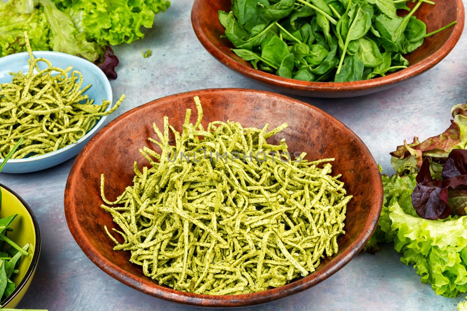 Italian cuisine vegan food Conchiglie pasta topped with spinach. Copy space.