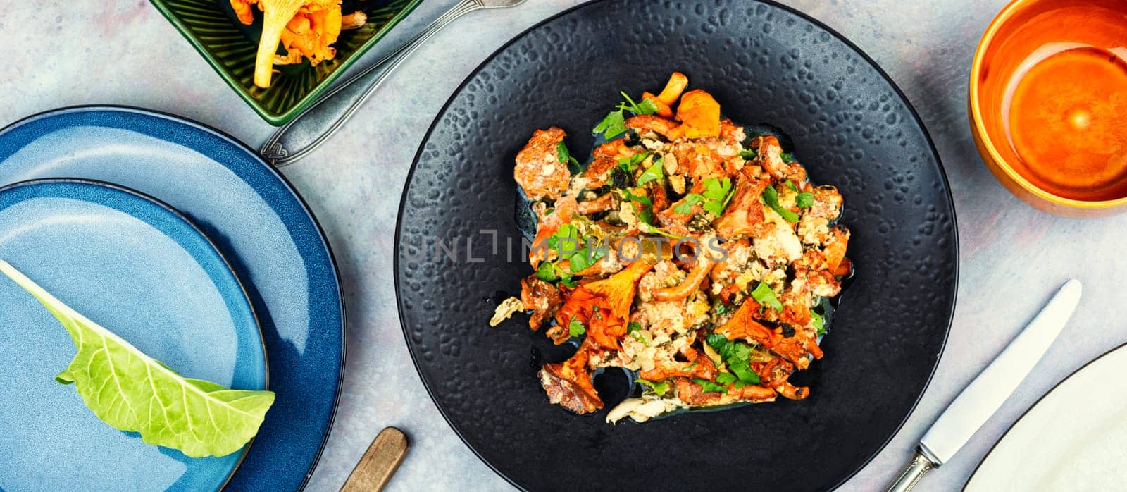 Frittata with fresh chanterelle mushrooms in plate on table. Breakfast.