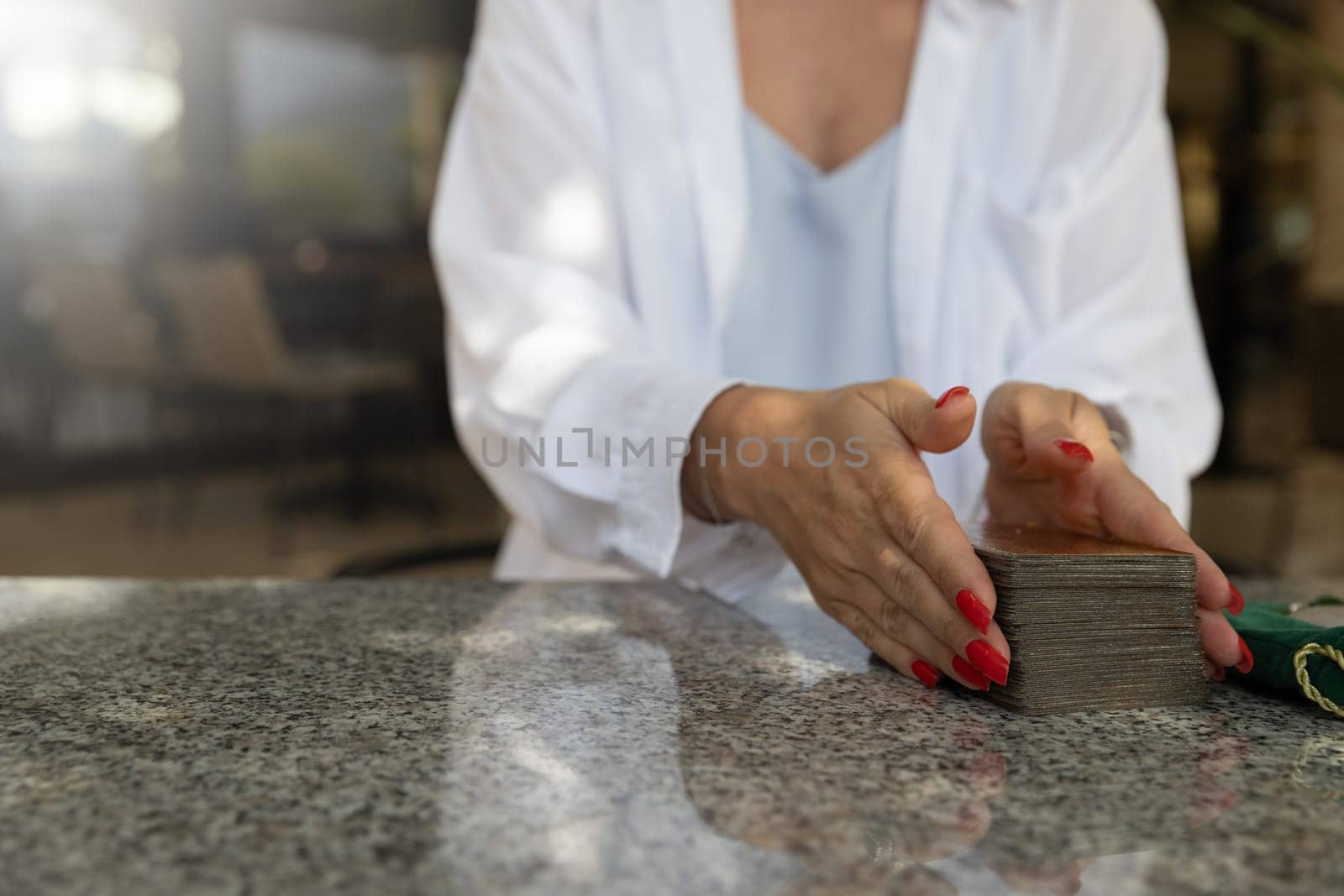 Young woman holding tarot cards. Concept of fortune telling, predictions, oracle and love magic on tarot cards.lifestyle or spirituality content