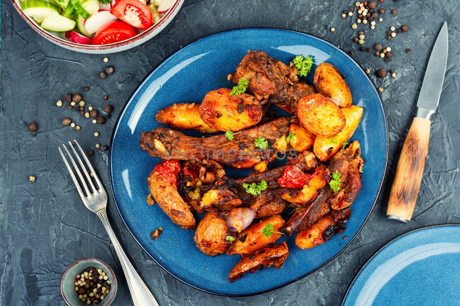 Spare ribs or grilled ribs with stewed vegetables. Barbecue ribs.